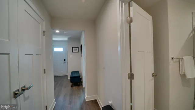 a view of a hallway with wooden floor