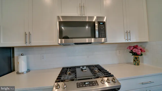 a kitchen with a stove and cabinets