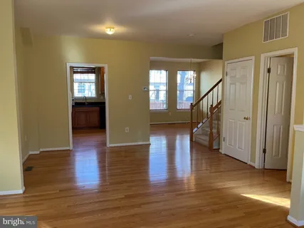 a view of entryway and hall with wooden floor