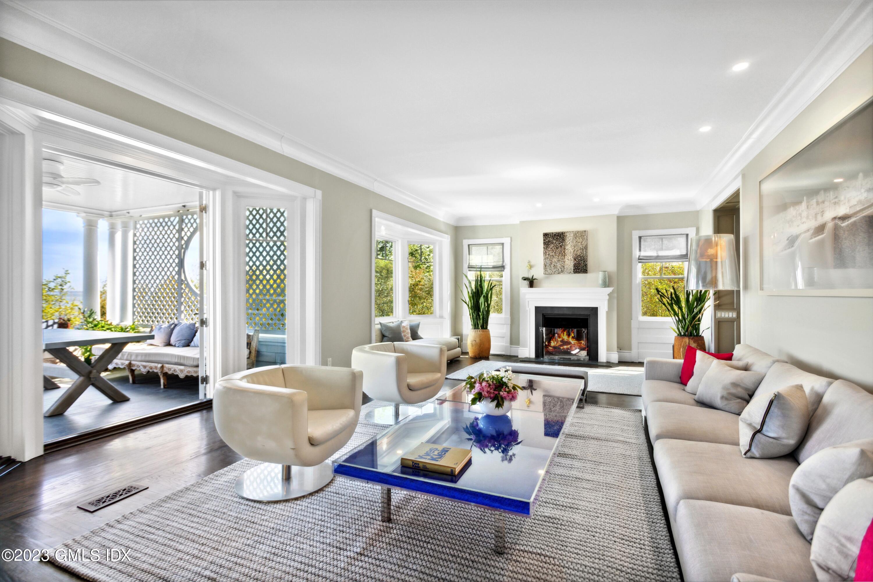 61 Byram Shore Road Greenwich, CT 06830 - Photo 8 of 36 a living room with furniture couches and a fireplace