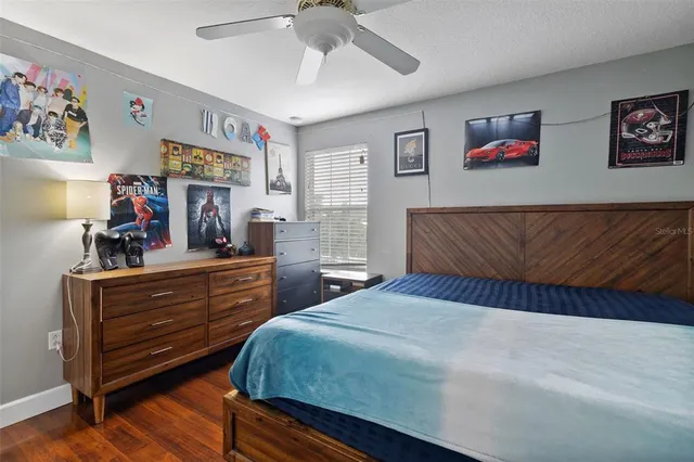 a view of a livingroom with wooden floor and a ceiling fan