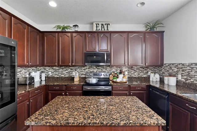 a view of a workspace with furniture and a flat screen tv