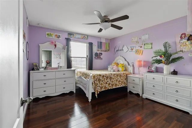 a bedroom with a bed and a dresser in it