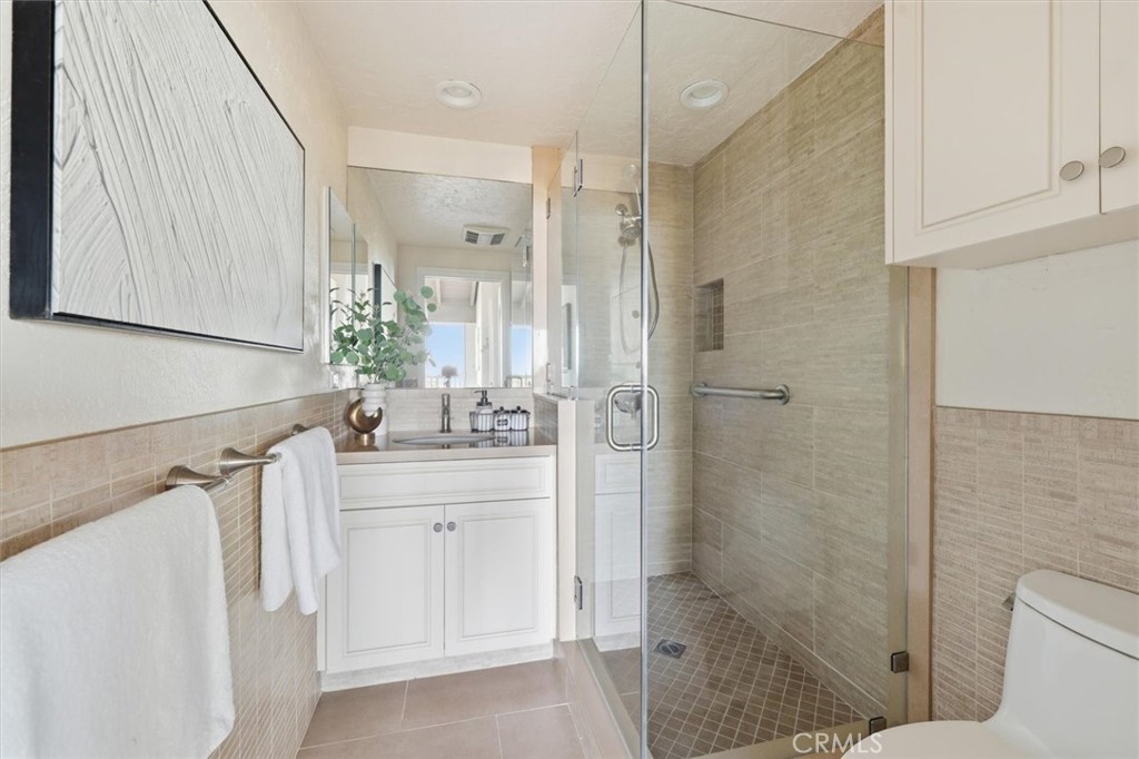 1308 Vía Coronel Palos Verdes Estates, CA 90274 - Photo 15 of 74 a bathroom with a shower sink and mirror