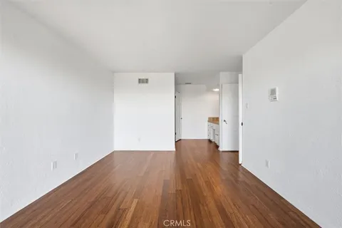 a view of an empty room with a fireplace and a window