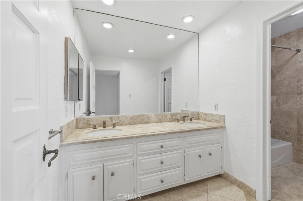 1308 Vía Coronel Palos Verdes Estates, CA 90274 - Photo 58 of 74 a bathroom with a granite countertop double vanity sink and mirror