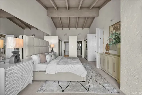 a view of a bedroom with a bed and glass door