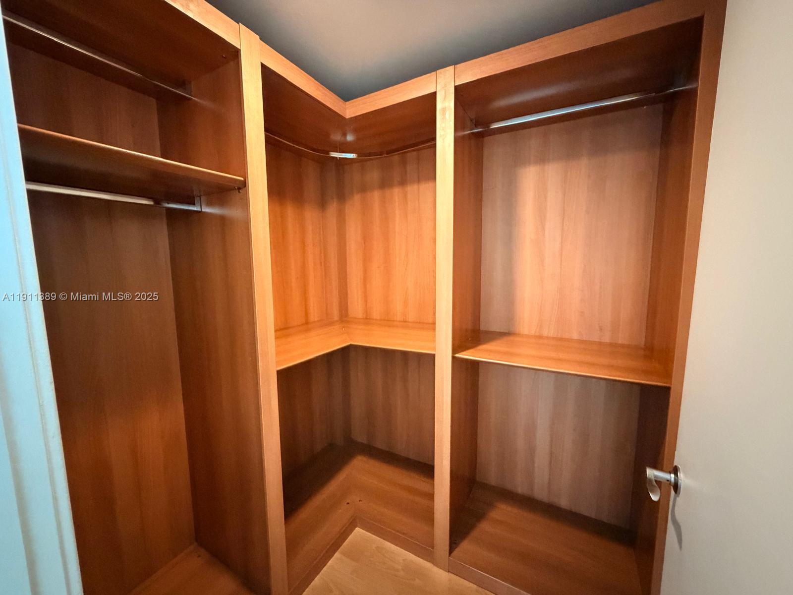 218 Southeast 14th Street, Unit 2102 Miami, FL 33131 - Photo 13 of 19 a view of walk in closet with empty racks