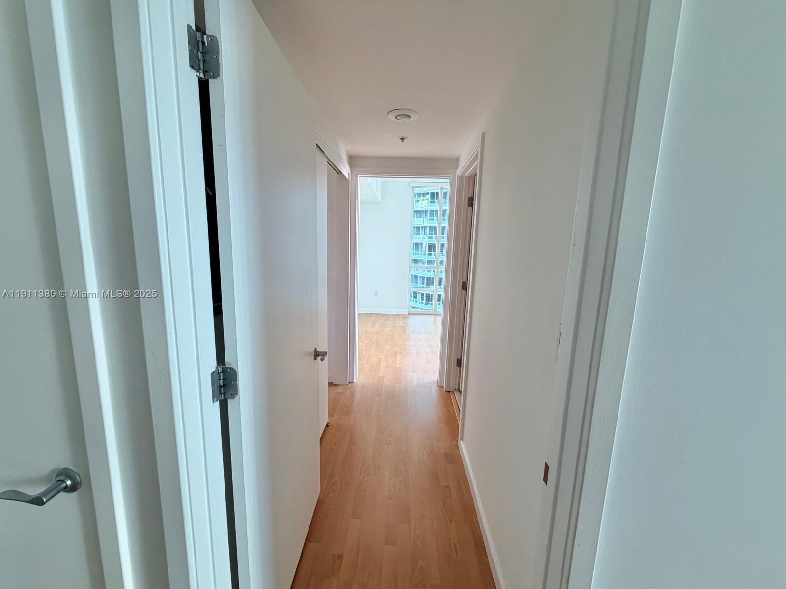 218 Southeast 14th Street, Unit 2102 Miami, FL 33131 - Photo 14 of 19 a view of a hallway with wooden floor