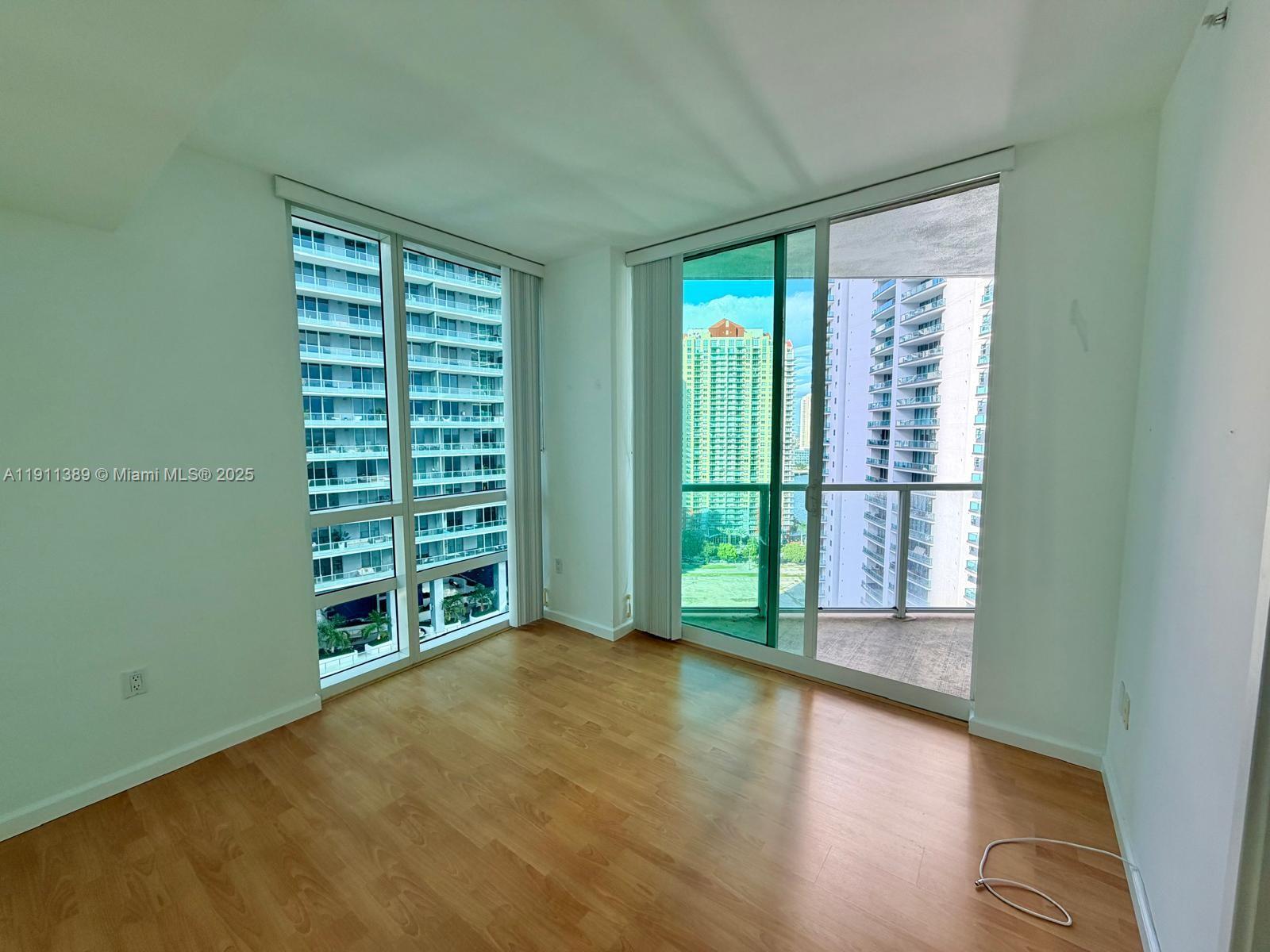 218 Southeast 14th Street, Unit 2102 Miami, FL 33131 - Photo 5 of 19 a view of an empty room with windows