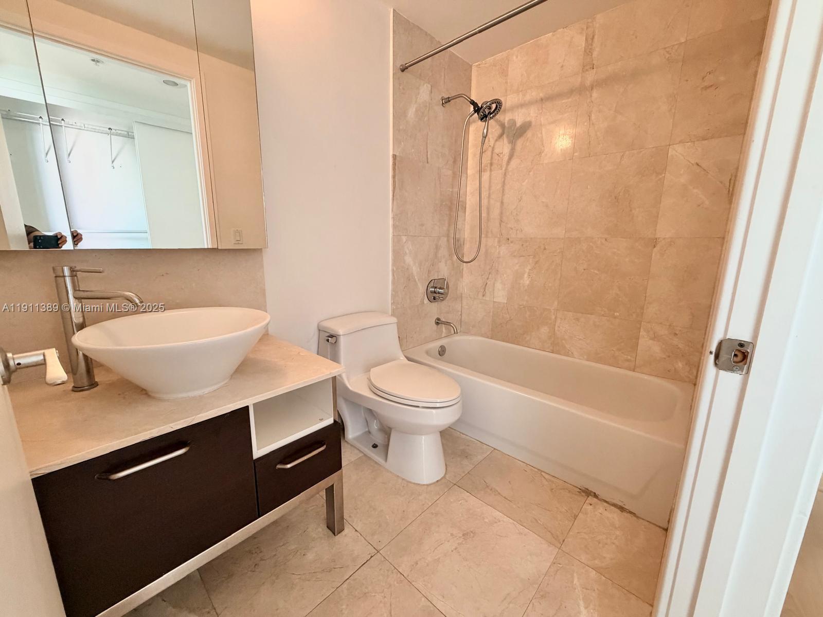 218 Southeast 14th Street, Unit 2102 Miami, FL 33131 - Photo 9 of 19 a bathroom with a sink a toilet and a bathtub