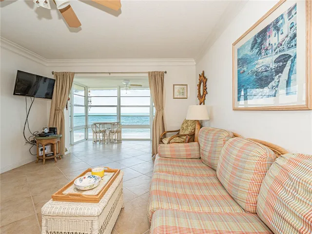 a living room with furniture and a floor to ceiling window
