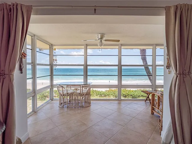 a view of a porch with a table and chairs