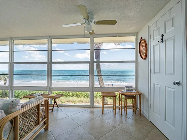 a view of a hallway with furniture and a window