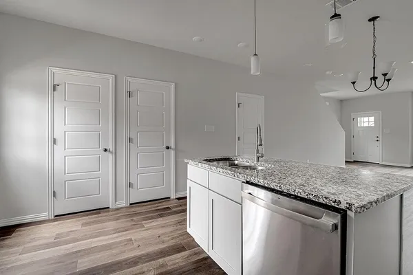 a kitchen with stainless steel appliances granite countertop cabinets and wooden floor