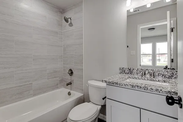 a bathroom with a sink toilet tub vanity and shower