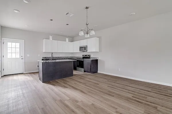 a kitchen with stainless steel appliances granite countertop a stove and a sink