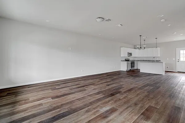 a view of kitchen and hall with wooden floor