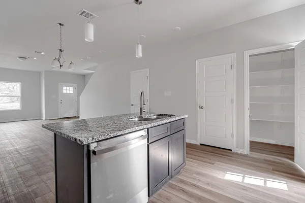 a kitchen with a table and chairs