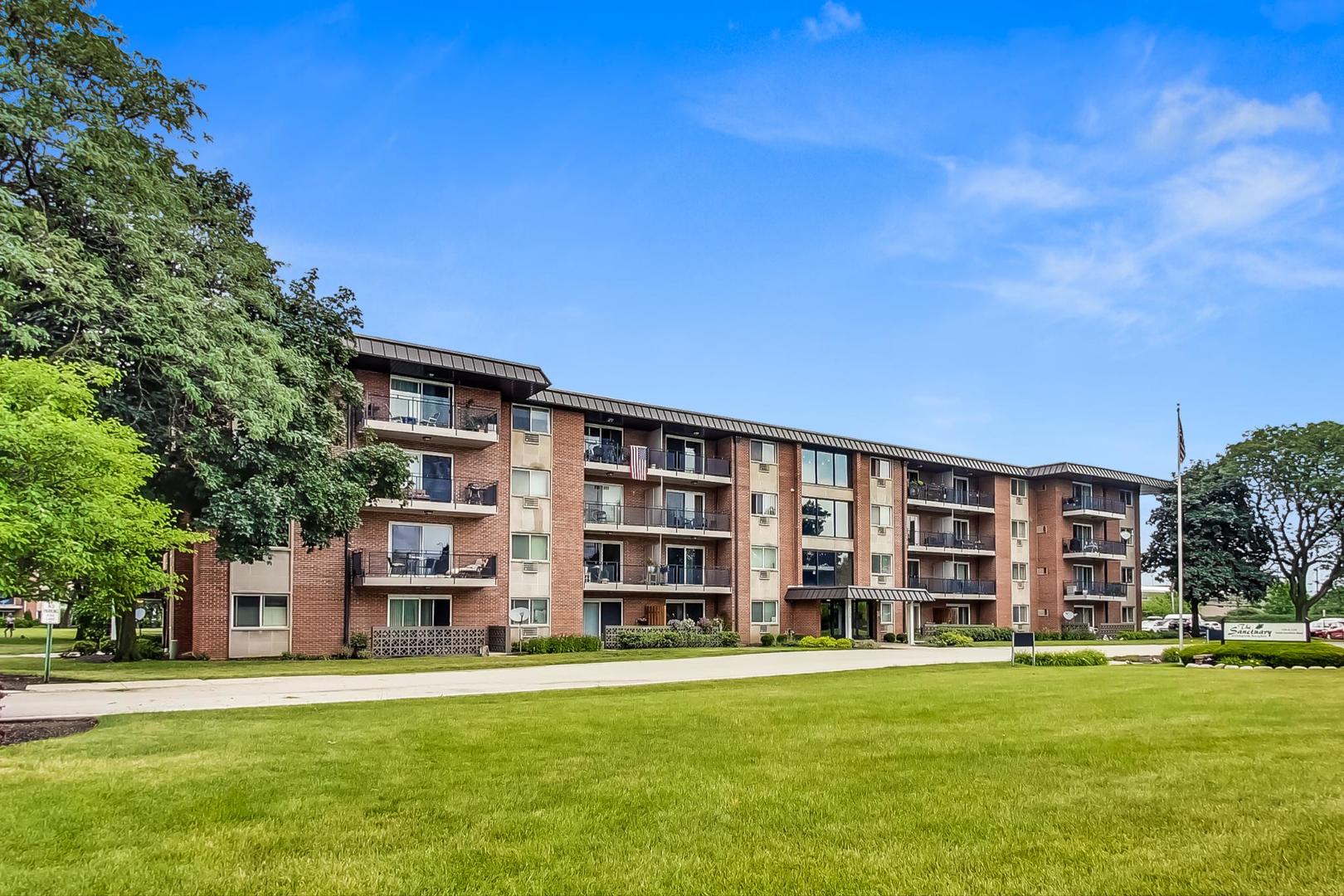 2234 South Goebbert Road, Unit 425 Arlington Heights, IL 60005 - Photo 1 of 20 a front view of a building with a garden
