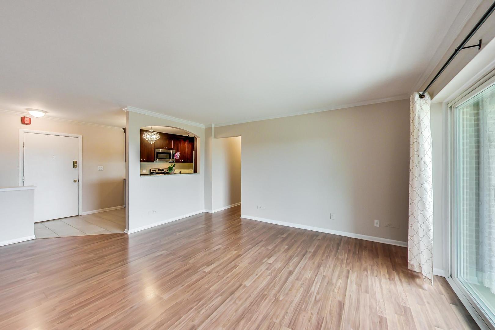2234 South Goebbert Road, Unit 425 Arlington Heights, IL 60005 - Photo 8 of 20 wooden floor in an empty room with a window