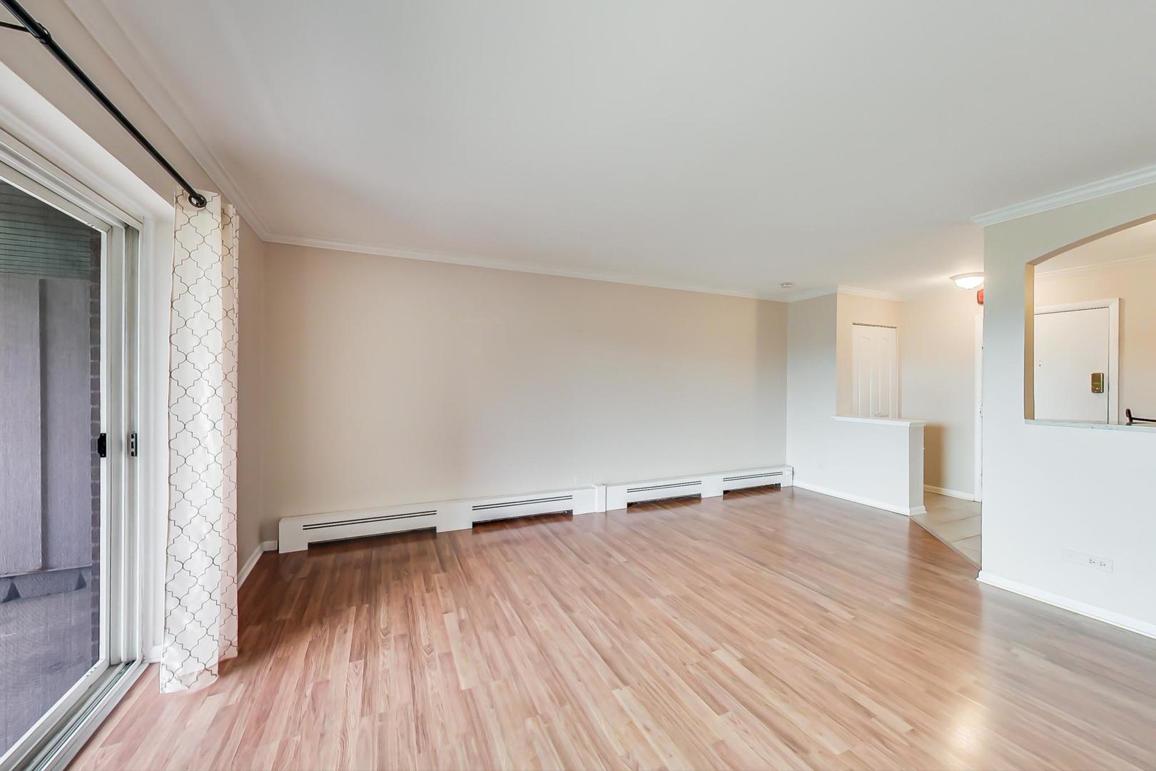 2234 South Goebbert Road, Unit 425 Arlington Heights, IL 60005 - Photo 9 of 20 wooden floor in an empty room with a window