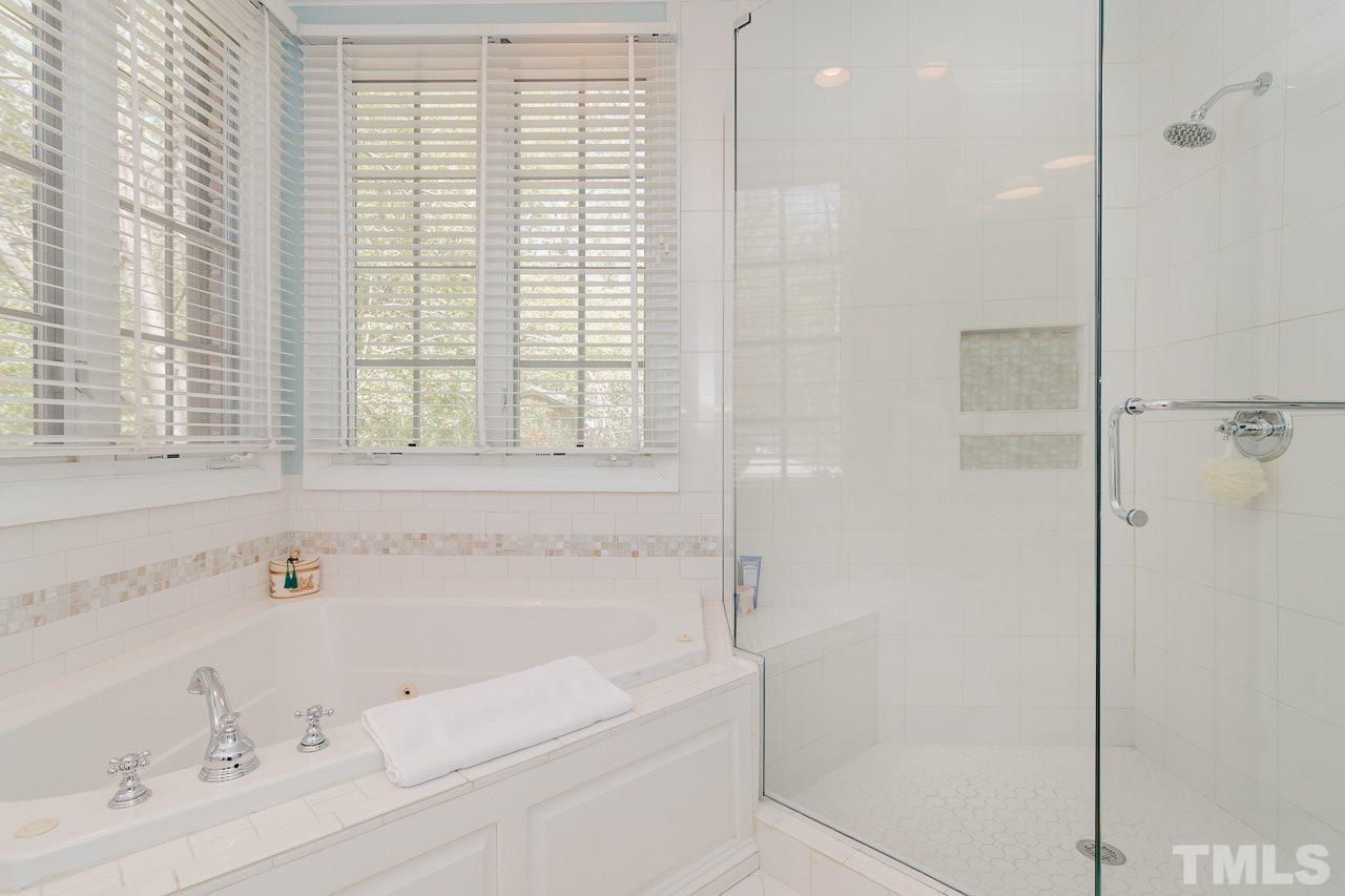 407 Forsyth Street Raleigh, NC 27609 - Photo 20 of 30 a bathroom with a bathtub and a shower