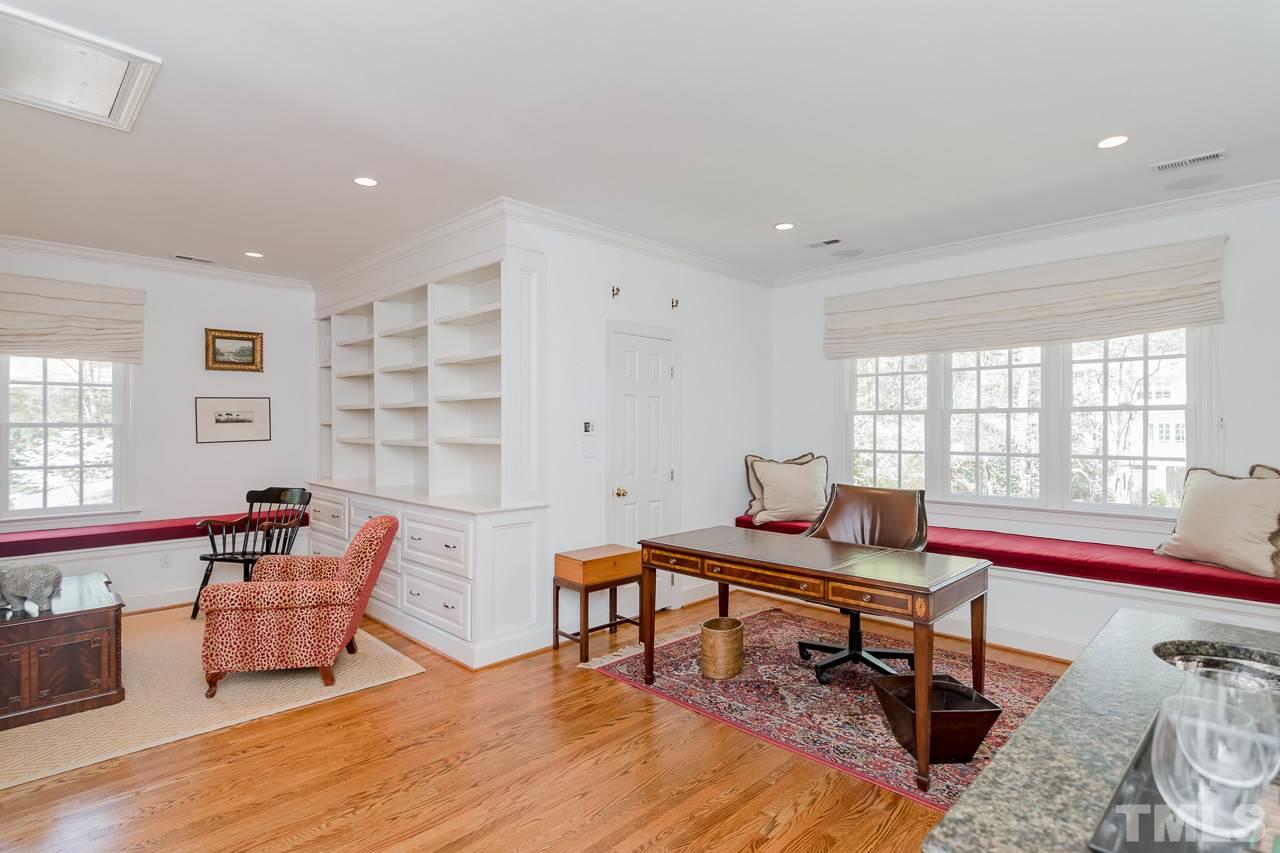 407 Forsyth Street Raleigh, NC 27609 - Photo 24 of 30 a living room with furniture and a wooden floor