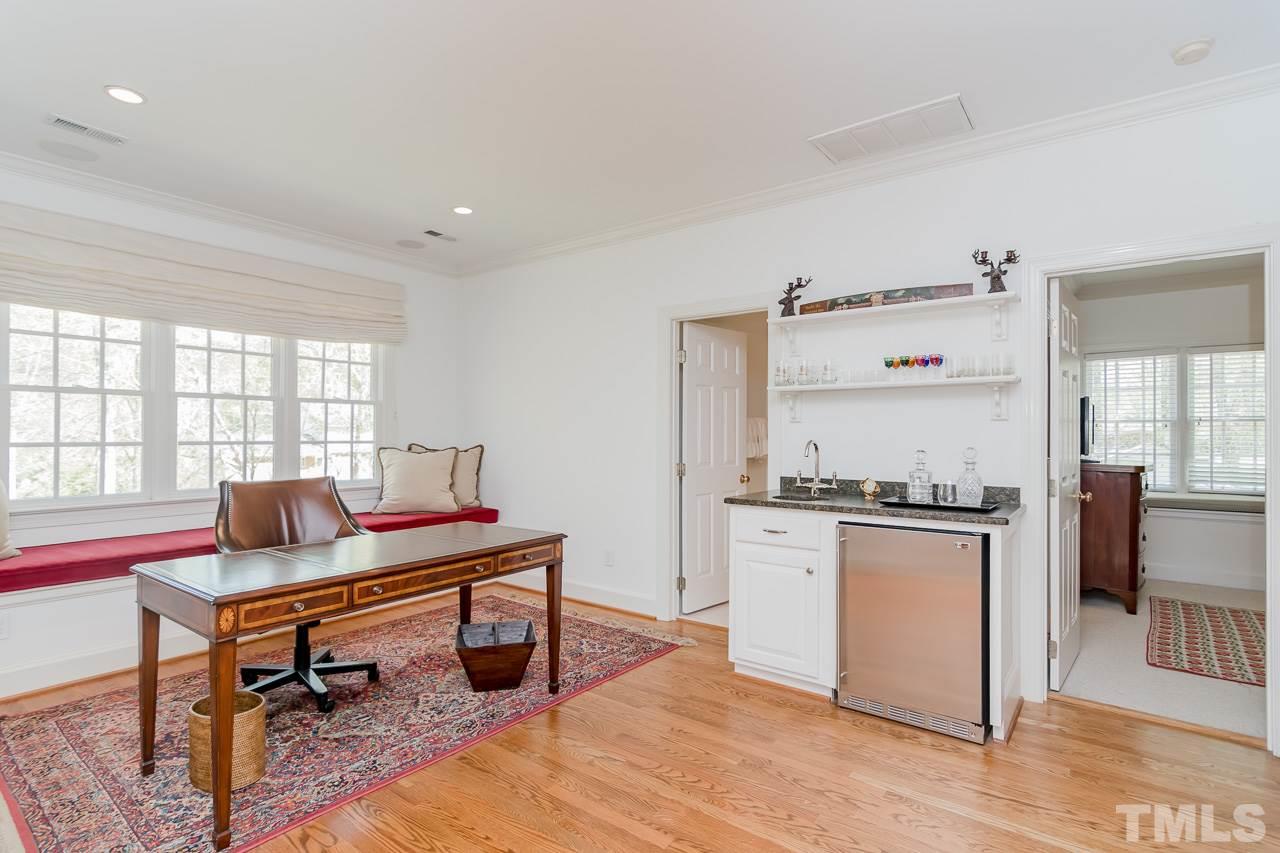 407 Forsyth Street Raleigh, NC 27609 - Photo 25 of 30 a work room with furniture a rug and a window