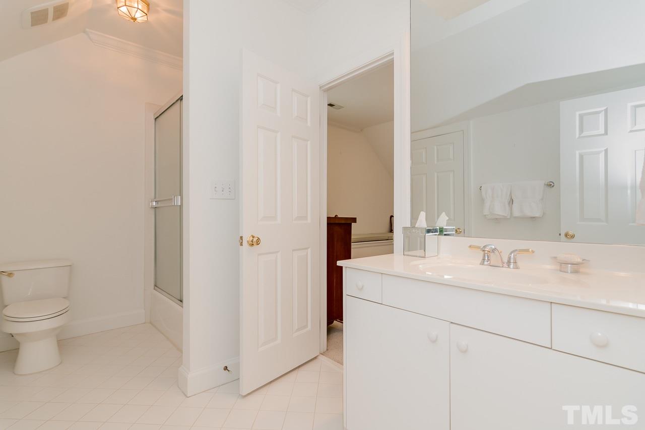 407 Forsyth Street Raleigh, NC 27609 - Photo 27 of 30 a bathroom with a sink toilet and mirror