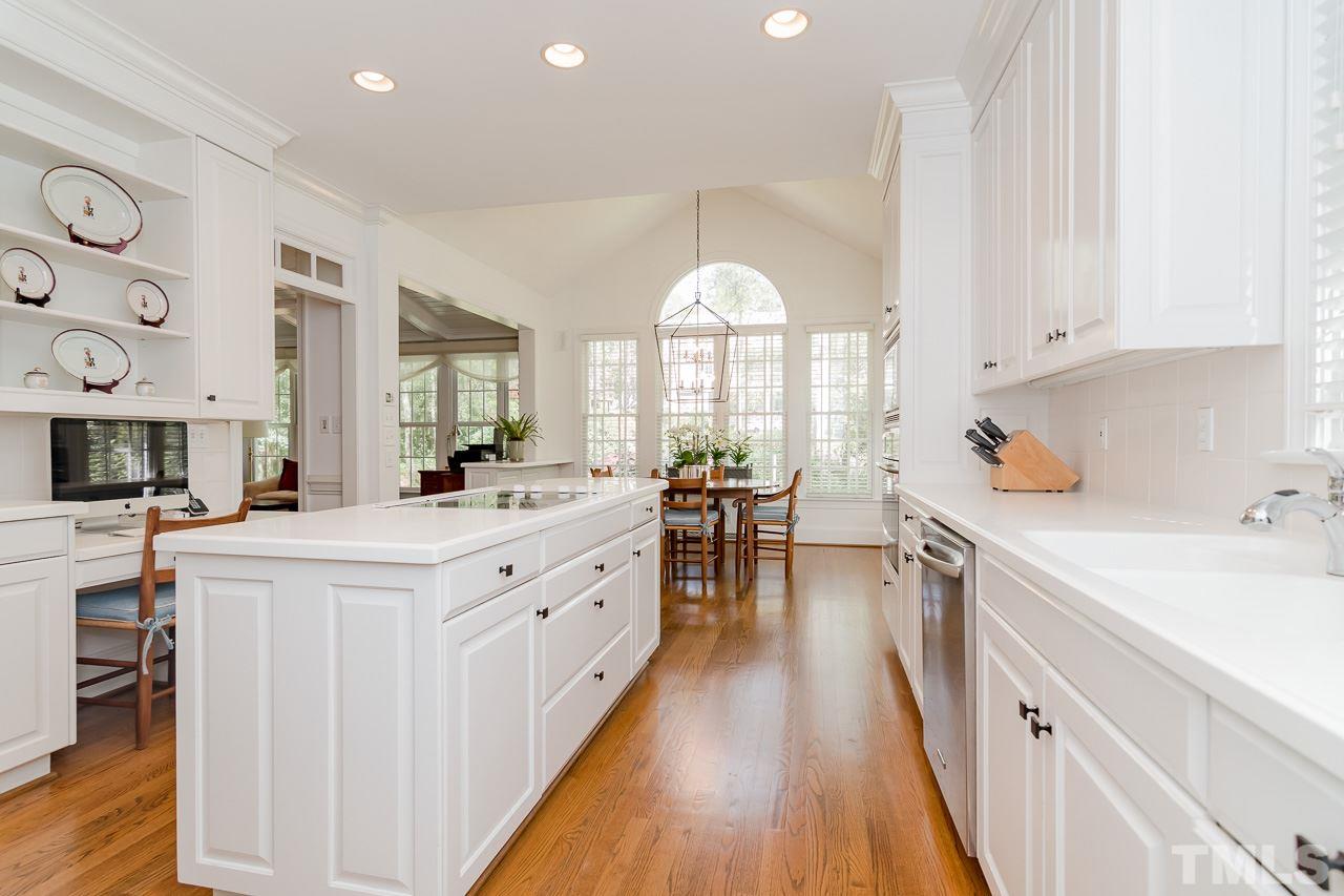 407 Forsyth Street Raleigh, NC 27609 - Photo 6 of 30 a kitchen with counter top space a sink appliances and cabinets