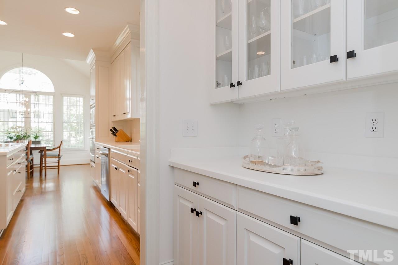 407 Forsyth Street Raleigh, NC 27609 - Photo 7 of 30 a kitchen with cabinets and chairs