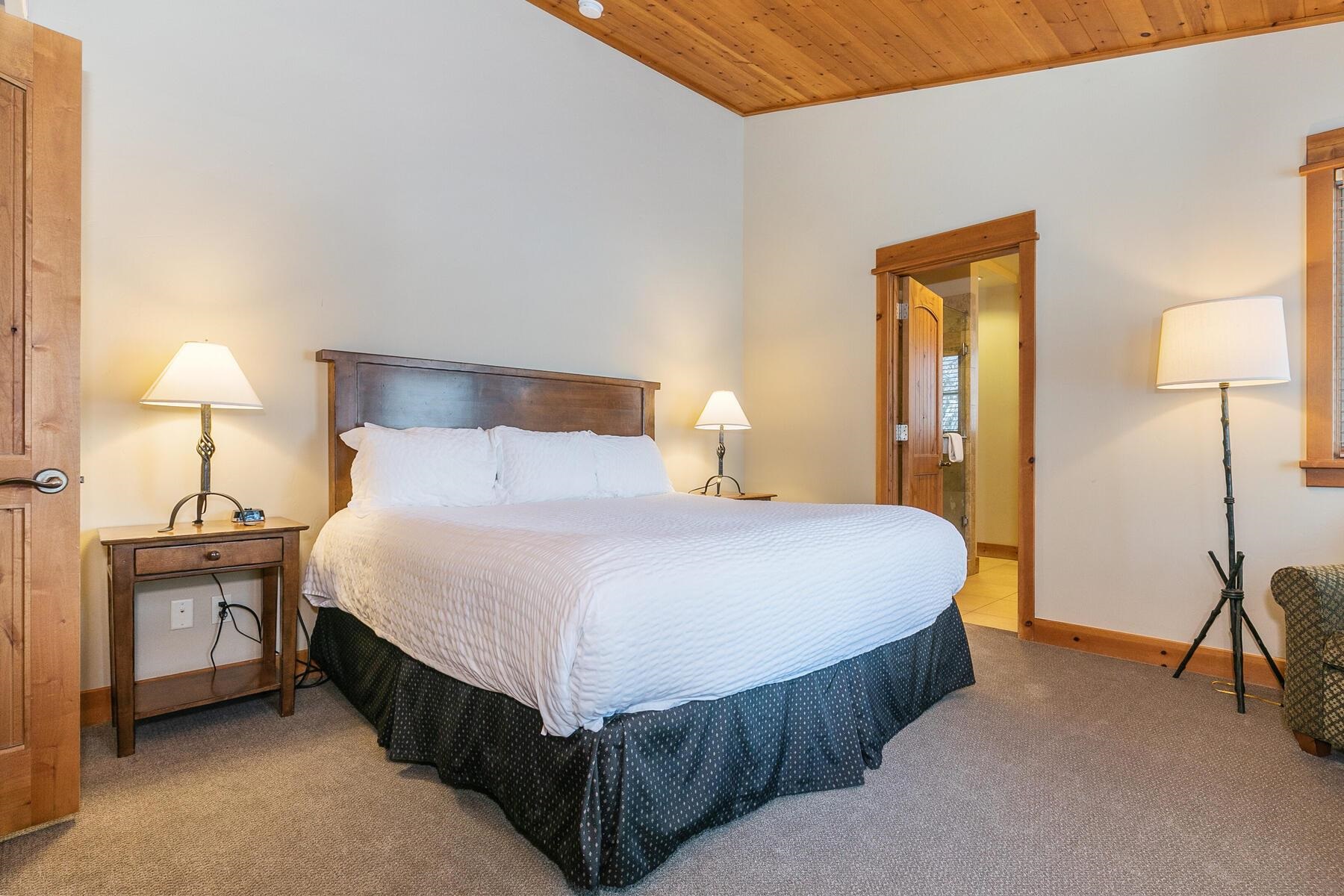 12258 Lookout Loop, Unit F2303 Truckee, CA 96161 - Photo 18 of 27 a bedroom with a bed and a lamp