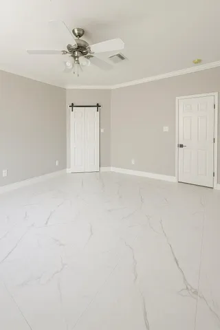 a view of an empty room with a ceiling fan