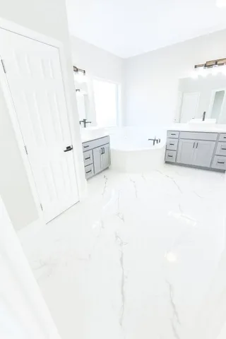 a large white tub sitting in a white room