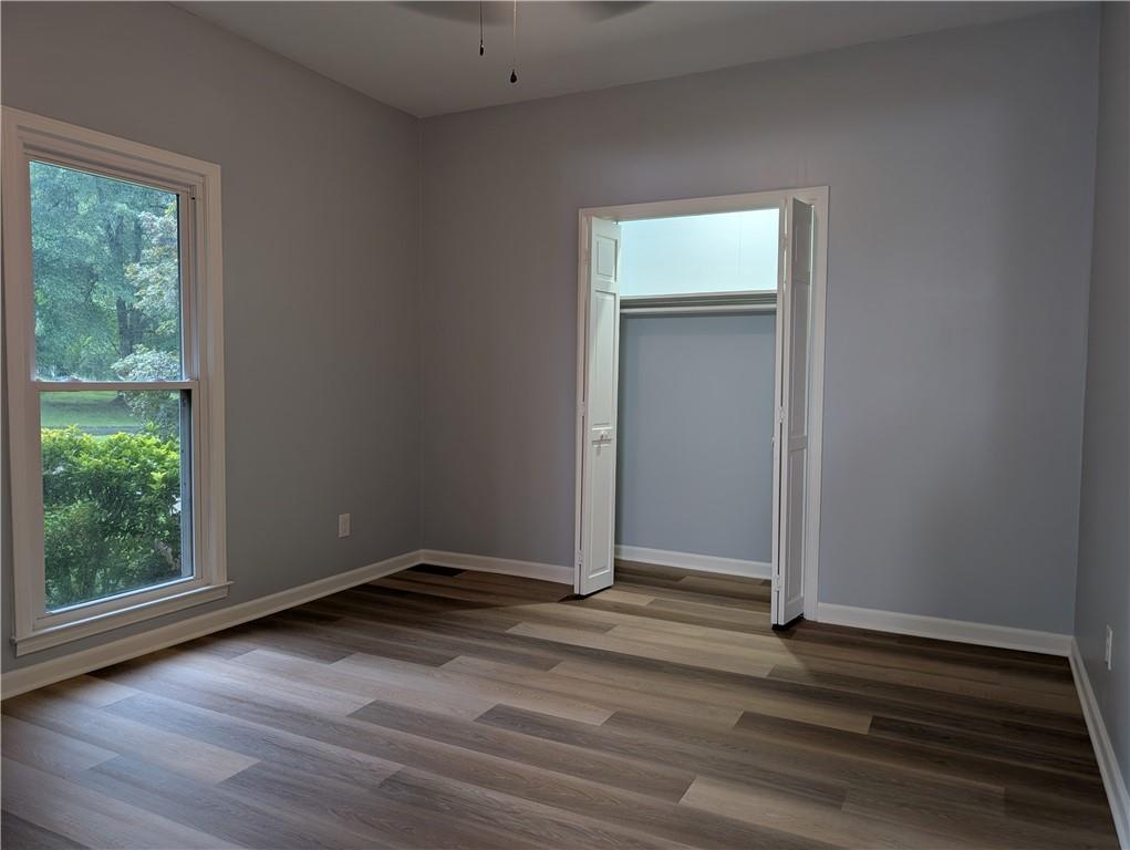 402 Pheasant Run Rome, GA 30161 - Photo 56 of 74 an empty room with wooden floor and windows