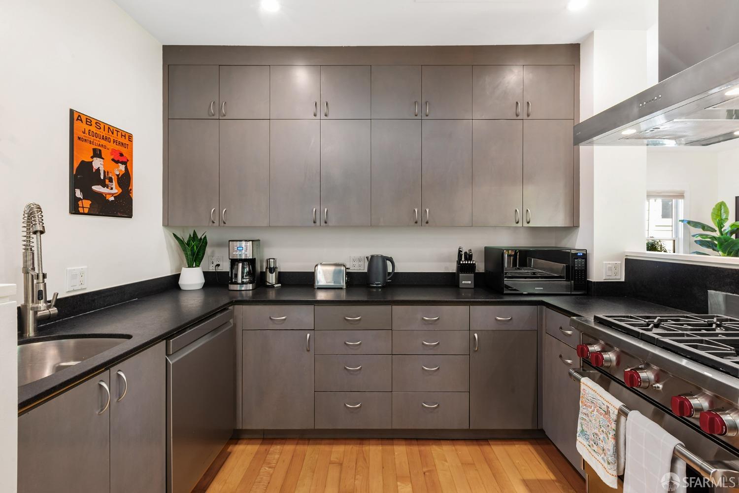 328 Harriet Street San Francisco, CA 94103 - Photo 14 of 41 a kitchen with granite countertop a sink a stove and cabinets