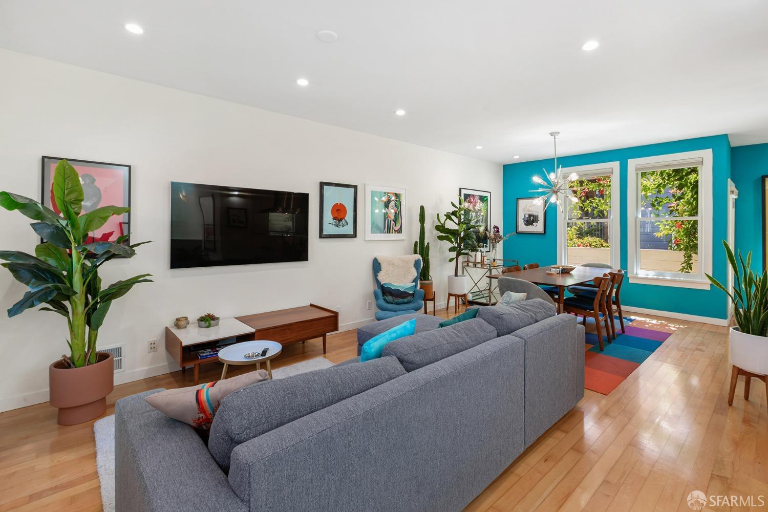 328 Harriet Street San Francisco, CA 94103 - Photo 10 of 41 a living room with furniture floor to ceiling window and a flat screen tv