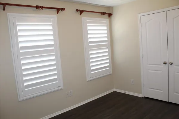 a view of a room with a hardwood and a window