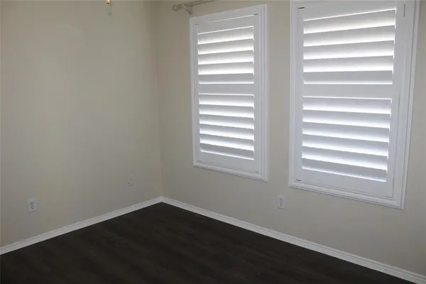 a view of a yard with wooden fence