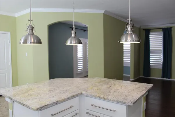 a kitchen with granite countertop a stove and a microwave oven