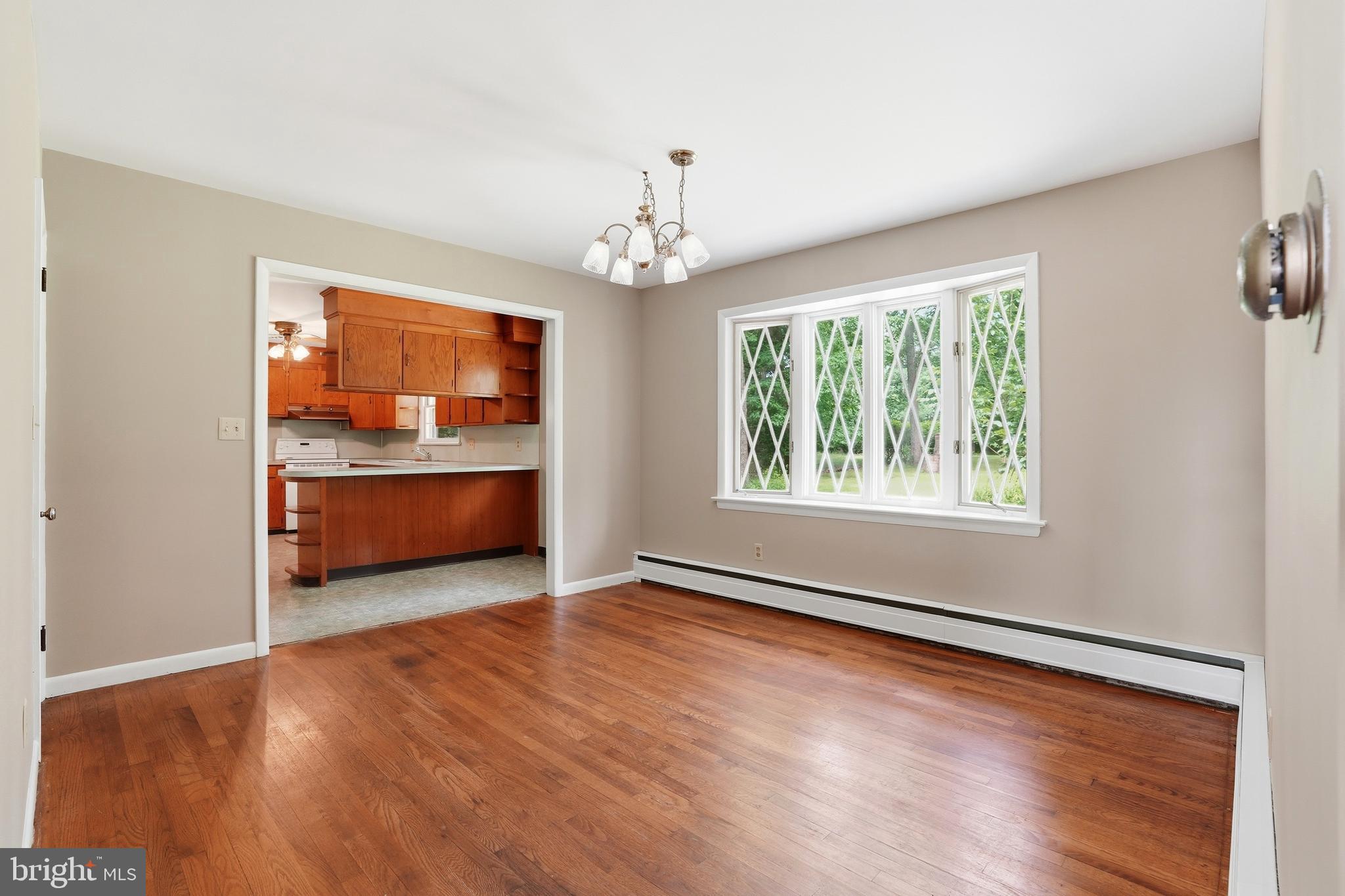 486 Derstine Road Hatfield, PA 19440 - Photo 9 of 53 an empty room with wooden floor chandelier and windows