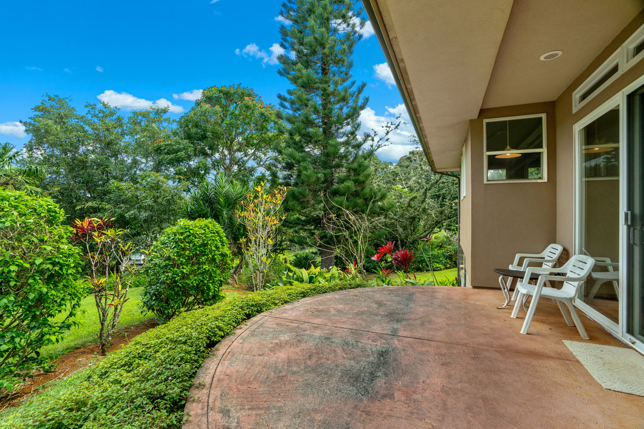 597 Puuopae Road Kapaa, HI 96746 - Photo 13 of 30 a view of a chair and tables in the back yard of the house