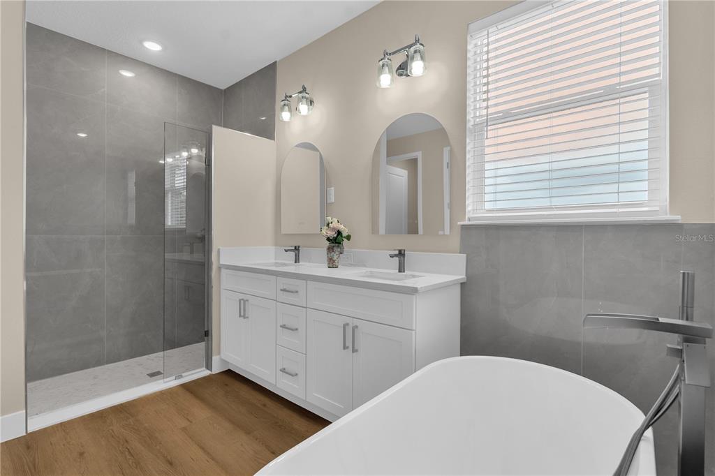2008 River Hawk Loop Winter Haven, FL 33880 - Photo 26 of 37 a bathroom with a double vanity sink a mirror and a shower