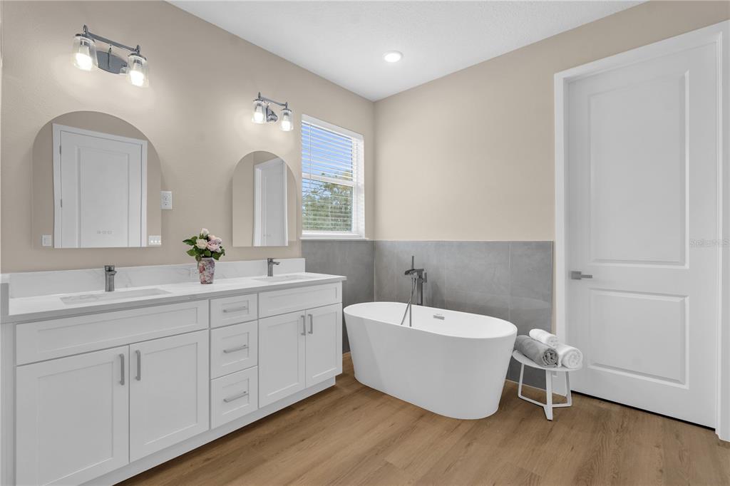 2008 River Hawk Loop Winter Haven, FL 33880 - Photo 27 of 37 a bathroom with a white tub sink and mirror