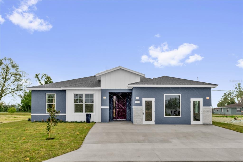 2008 River Hawk Loop Winter Haven, FL 33880 - Photo 3 of 37 a front view of a house with a garden and porch