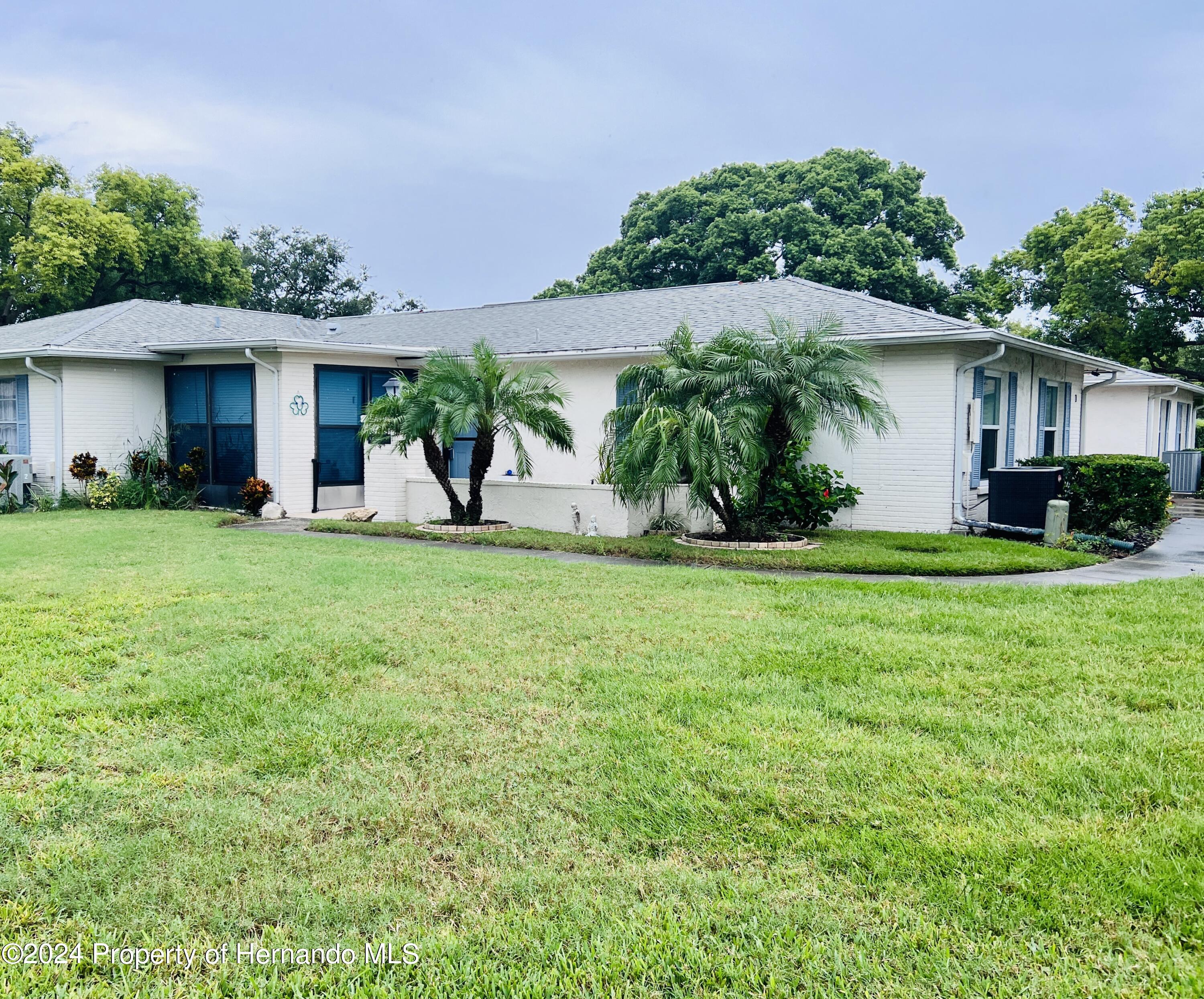 8141 Bugle Court Port Richey, FL 34668 - Photo 1 of 25 a view of a house with a yard