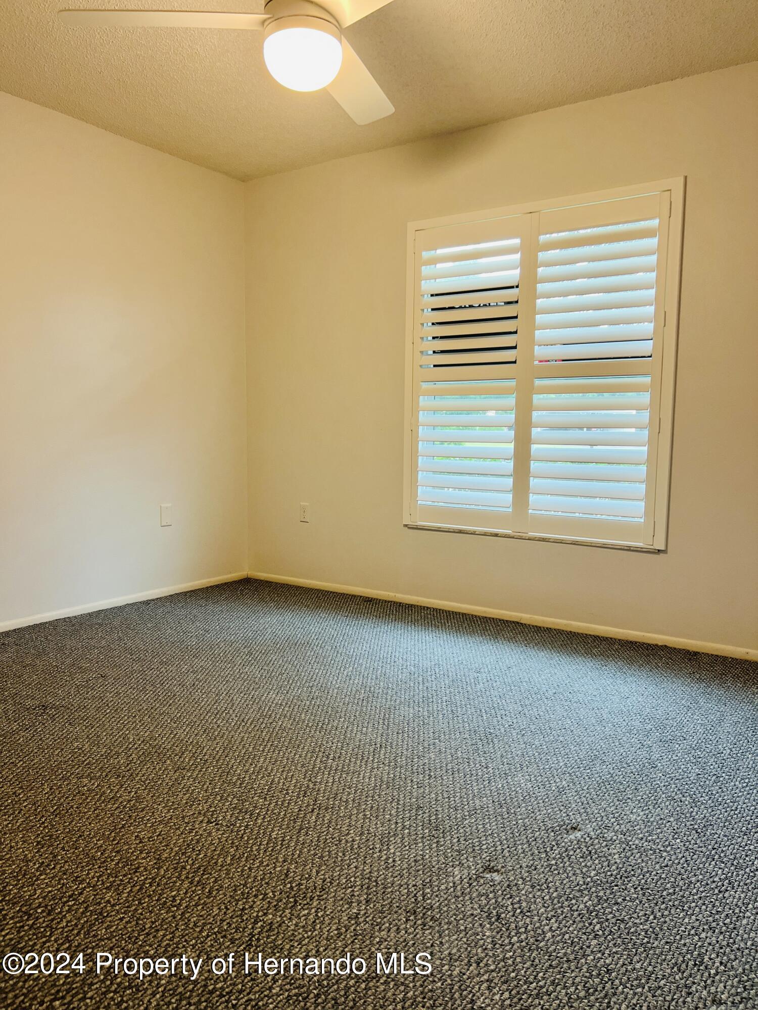 8141 Bugle Court Port Richey, FL 34668 - Photo 20 of 25 an empty room with a exposed radiator