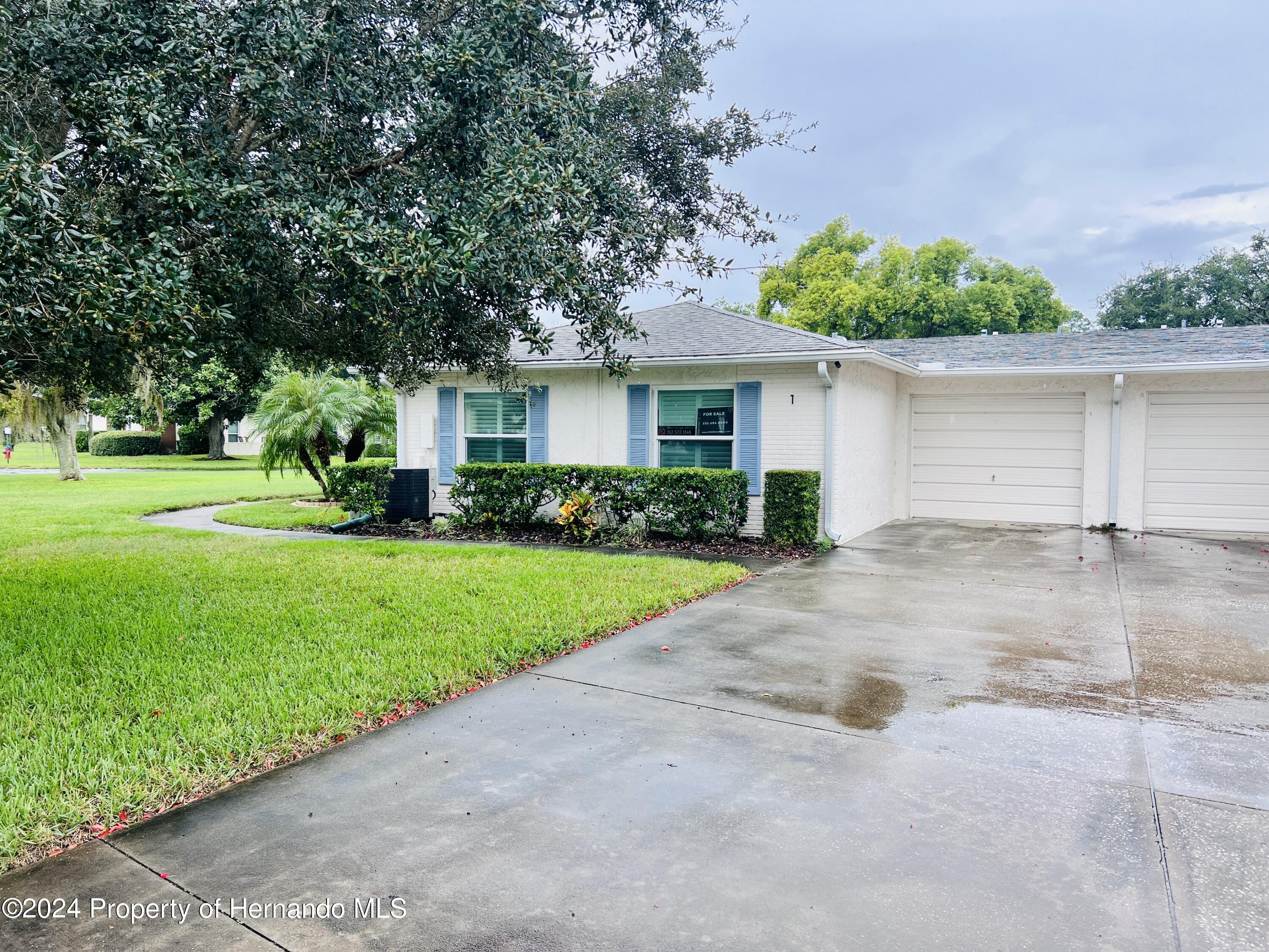 8141 Bugle Court Port Richey, FL 34668 - Photo 3 of 25 a view of a house with a yard and potted plants