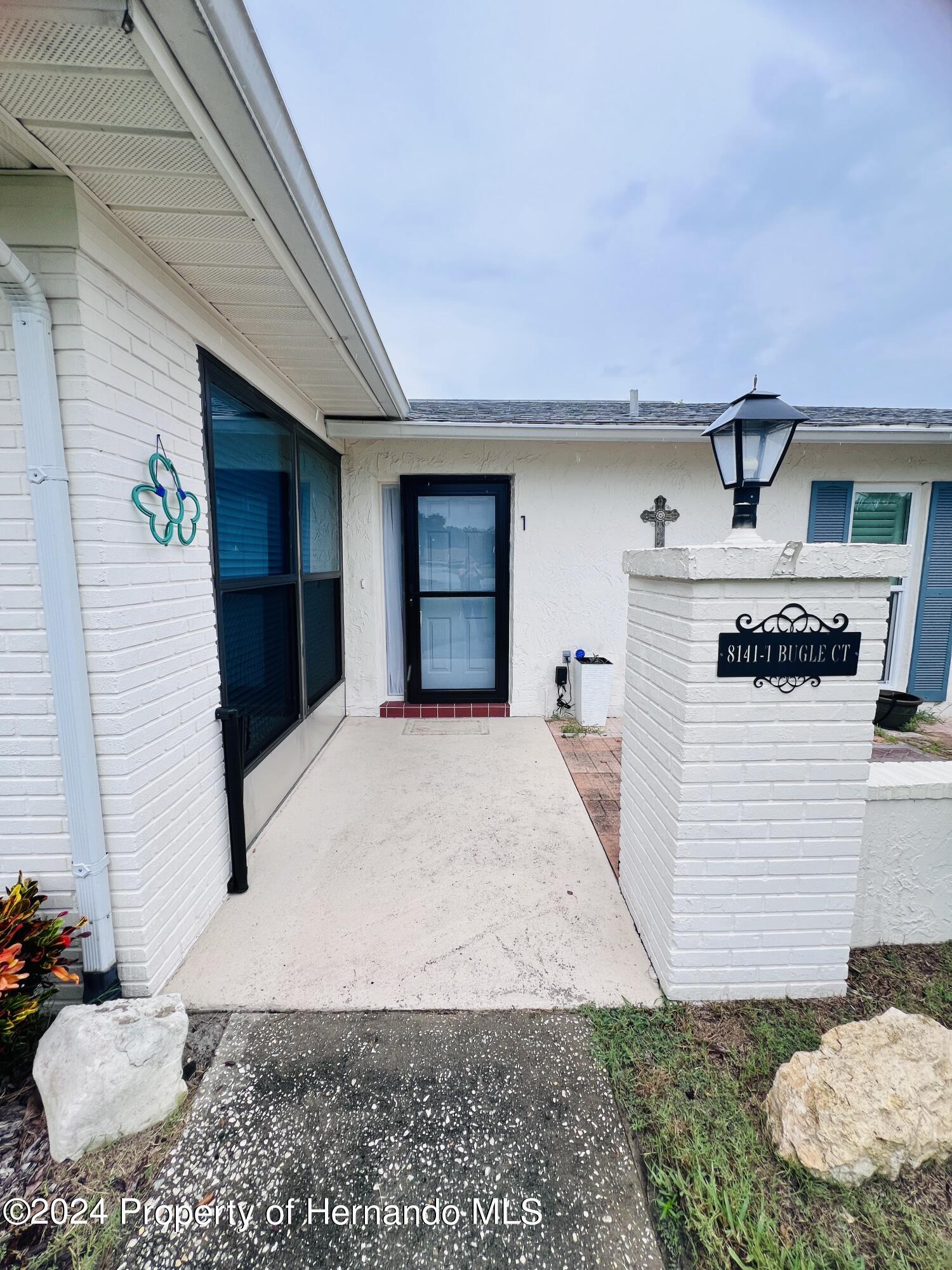 8141 Bugle Court Port Richey, FL 34668 - Photo 4 of 25 a front view of a house with a yard